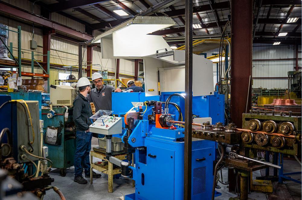 tube-fabricator-rebuilds-line-of-cutoff-machines-1677100823 Operator running Ringmaster tube cutting machine for continuous high-volume ring production