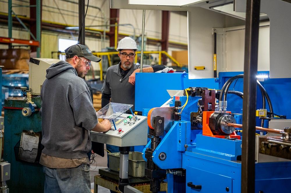 Operator running Ringmaster tube cutting machine for continuous high-volume ring production